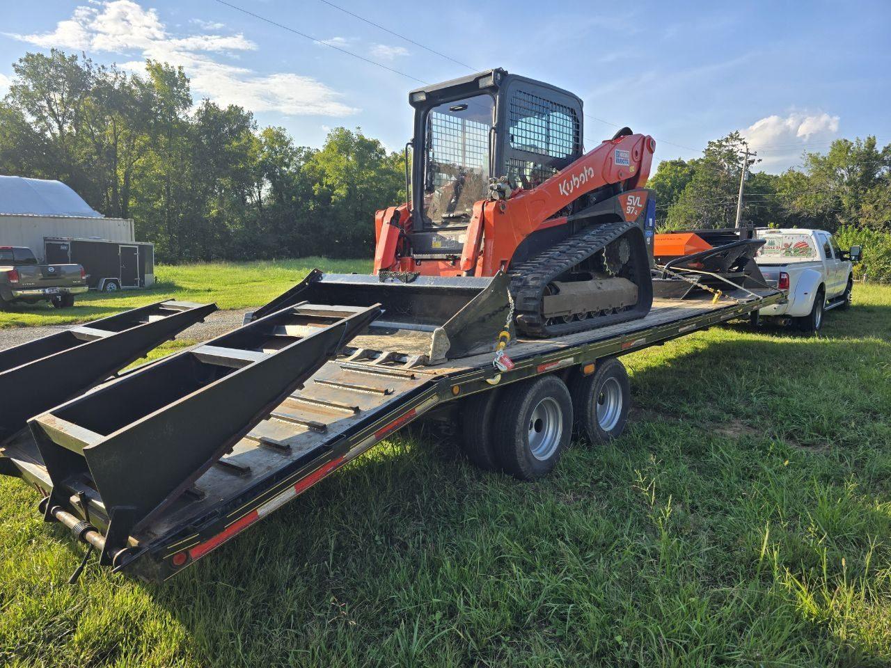 Kubota track loader with a brush hog attachment on a trailer