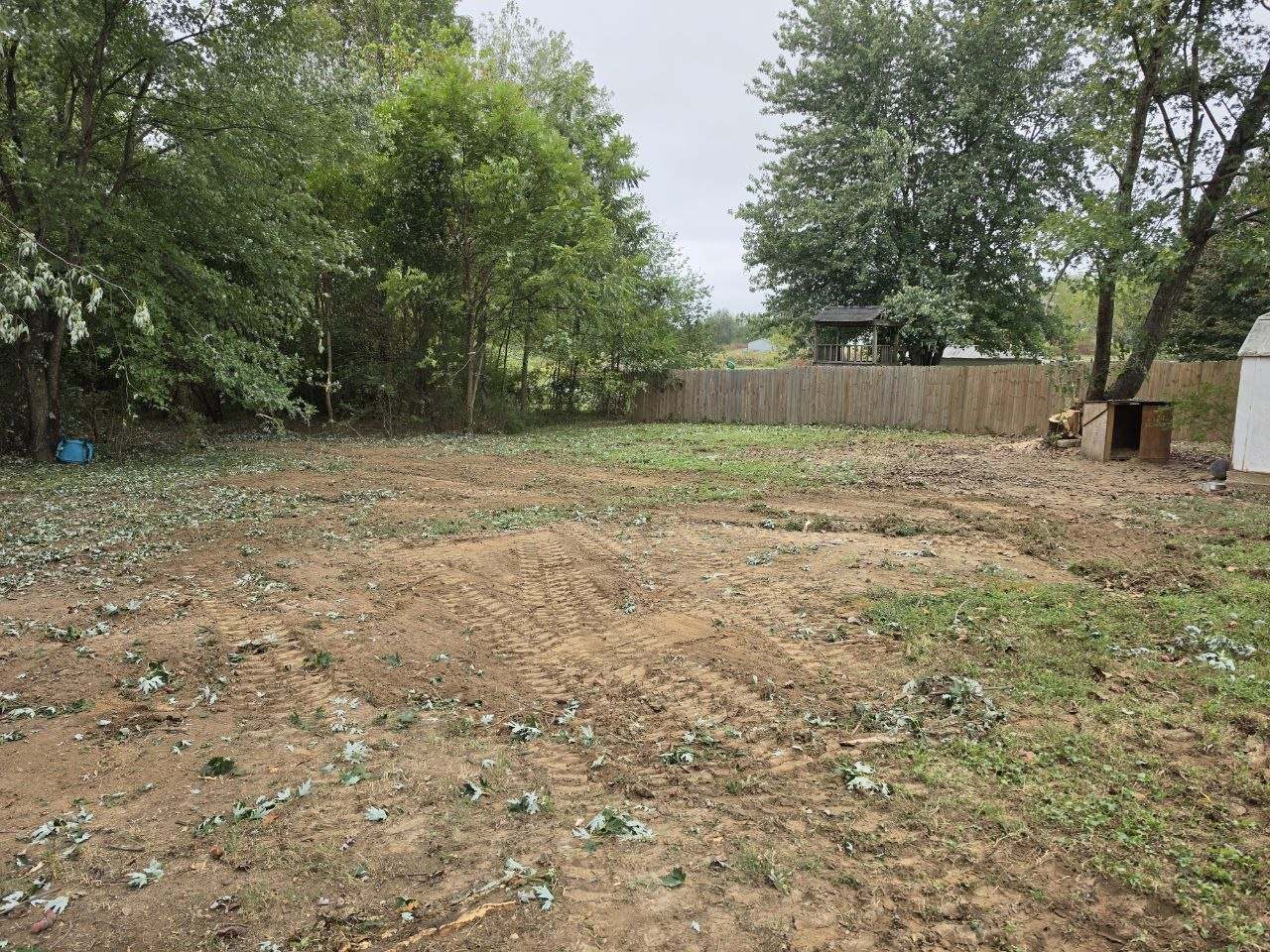 Backyard cleared and graded after storm cleanup in Lawrenceburg, TN