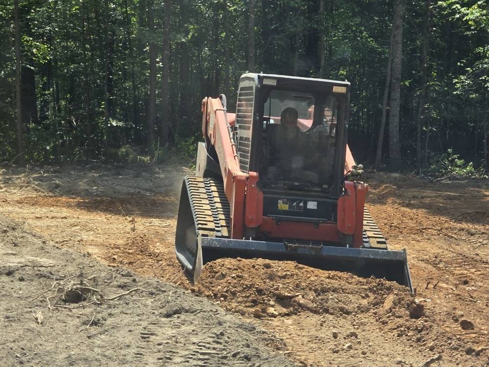 Kubota SVL 97-2 track loader grading a building pad